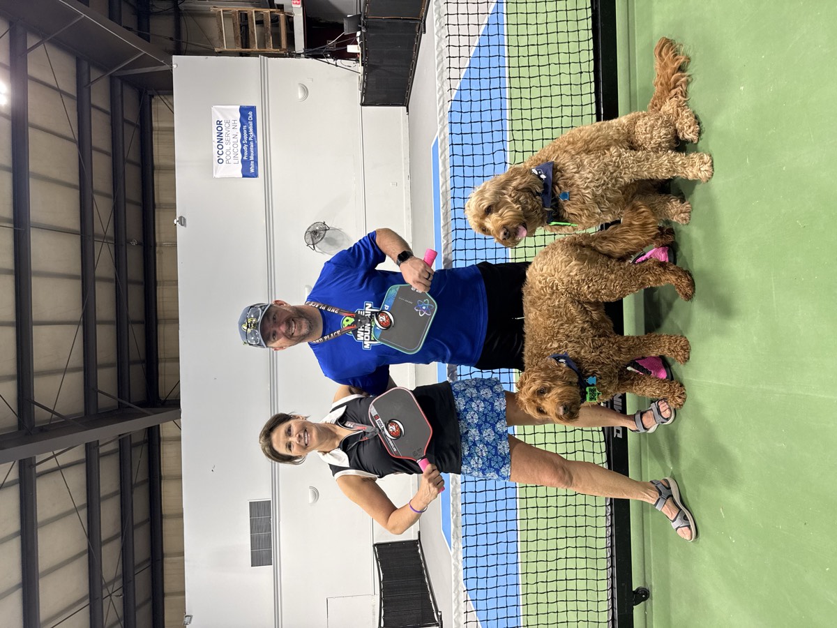 WMPC members gathered at the net with paddles after a tournament