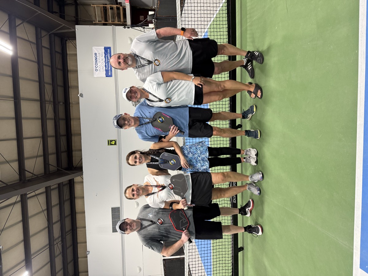 WMPC players with medals and paddles at the net
